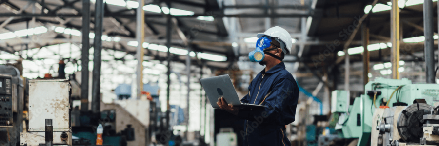 Industrial employee with safety gear on in the working facility.