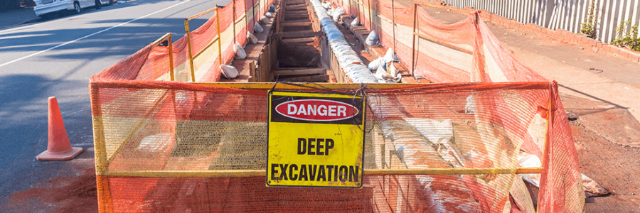 Precaution signs and railing around excavation site